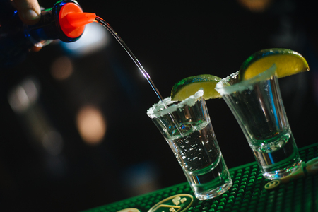 Alcohol bar, cocktail glass on bar counter, cocktail glass in a bar, Drinking cocktail in bar, cocktail in the glass with straws, Fresh drink coctailの写真素材