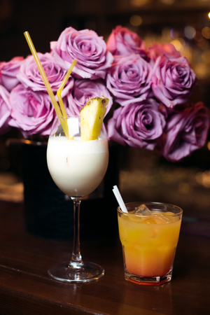 Alcohol bar, cocktail glass on bar counter, cocktail glass in a bar, Drinking cocktail in bar, cocktail in the glass with straws, Fresh drink coctailの写真素材