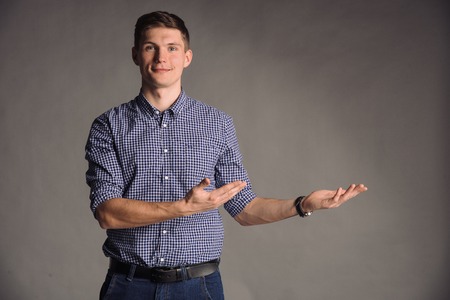 Colored portrait of smiling man isolated on gray studio background posing to the cameraの写真素材