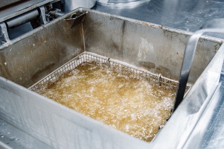 Process of making fried chicken on the kitchen. Restaurant or pizzeria cuisineの写真素材