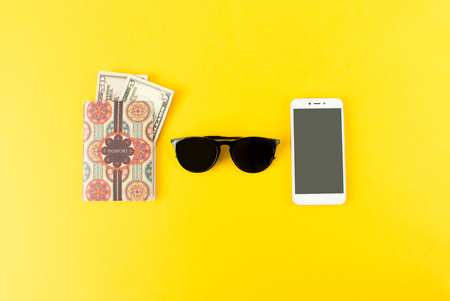 Portrait of objects: all you need in journey, voyage or travel. Passport, camera, sunglasses and smartphone.の写真素材