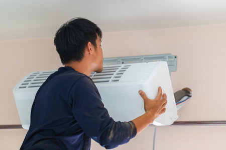 Air conditioning technicians install new air conditioners in homes, Repairman fix air conditioning...