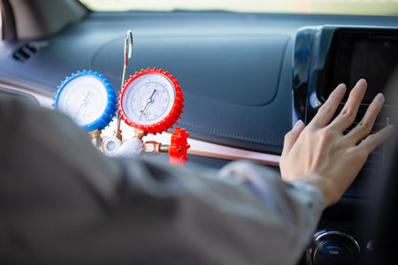 Technician check car air conditioning system refrigerant recharge, Repairman holding monitor tool to check and fixed car air conditioner system, Car Air Conditioning Repairの写真素材