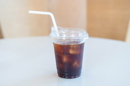 Iced coffee, A cup of iced americano coffee on the table, Plastic cup with lid and straw. Americanoの写真素材