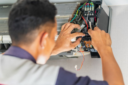 Technician man service fixing repair and maintenance of air conditioners, Repairman fix air conditioning systemsの写真素材