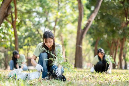 Young Volunteers Planting Tree for Environmental Conservation, Eco-Friendly Group Activity: Teamwork...
