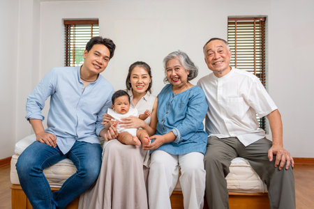 Happy Asian Multi-Generational Family Portrait, Joyful Grandparents, Parents, and Baby Together, Three Generations of an Asian Family Smilingの写真素材