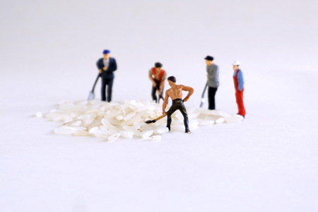 Miniature figures working loading shovels Fig. The concept of heavy manual work of workers, movers.