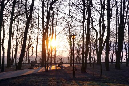 Morning dawn over the river with an empty bench in the Park.の写真素材