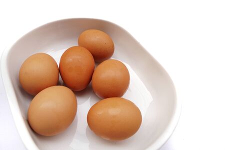 Top view of eggs isolated in a bowl on white backgroundの写真素材