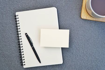 Office desk table with notebook and pen with blank card,page copy space for text.Flat lay business...