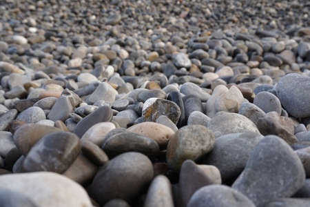 The coastline is filled with small rocks at nice beachの写真素材