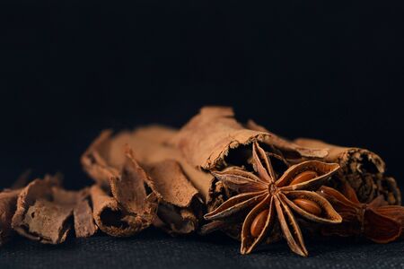 Star anise and cinnamon for tea arranged in an black backdrop.の写真素材