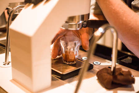 Barista Brewing Espresso Shot from Espresso Machineの写真素材