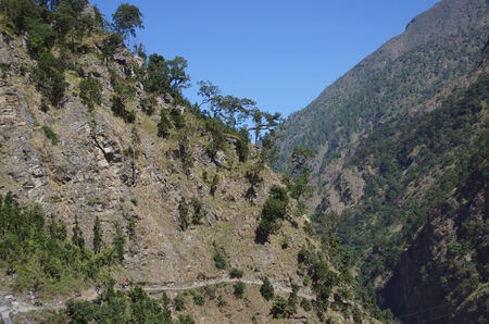  		 Mountain trail goes along the slope of the mountain Manaslu trekking around in Nepalの写真素材