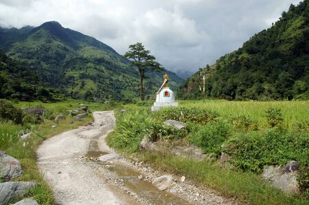 A small stupa by the roadside in the mountainsの写真素材