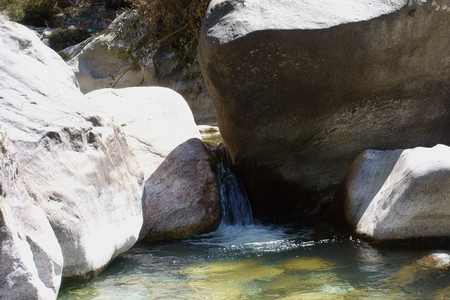 The flow of water through large rocksの写真素材
