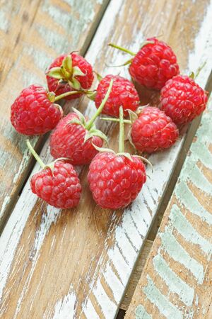 Red raspberry on old vintage wooden table.の写真素材