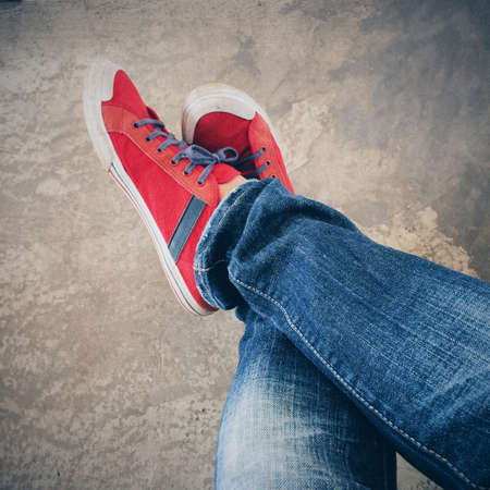 Blue jeans and red shoes in vintage style.の素材