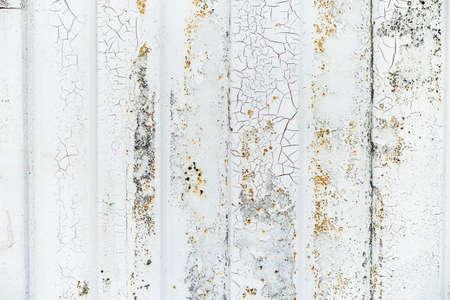 Close-up detail of grunge paint on rusty white metal wall.の写真素材