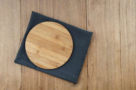 Blank bamboo wood chopping block on wooden table.の写真素材