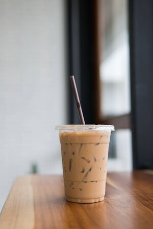 ice coffee on wooden table,ice coffee in take home glasses.の写真素材