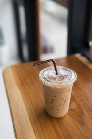 ice coffee on wooden table,ice coffee in take home glasses.の写真素材