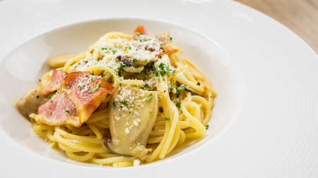 Spaghetti Carbonara.This recipe with Bacon Egg Mushroom Parmesan cheese and Spaghetti.Food styling on table.の写真素材