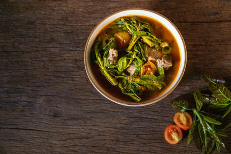 Traditional cuisine and recipe menu in Northern of Thailand."Ficus lacor Buch" with spices curry in pork bone soup.Thai food famous in Chiang Mai.の写真素材