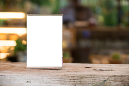 mock up menu object in cafe and restaurant,blank screen for booklet with white sheets of paper on wooden table on cafeteria,copy space for text or graphics objectの写真素材