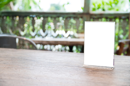 mock up menu object in cafe and restaurant,blank screen for booklet with white sheets of paper on wooden table on cafeteria,copy space for text or graphics objectの写真素材