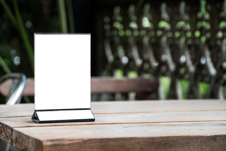 mock up menu object in cafe and restaurant,blank screen for booklet with white sheets of paper on wooden table on cafeteria,copy space for text or graphics objectの写真素材