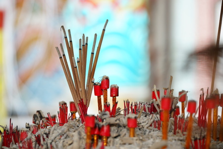Incense sticks on joss stick pot are burning and smoke use for pay respect to the Buddha.の写真素材