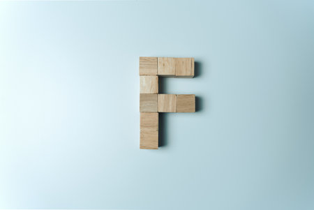Letter F from wooden dice White Backgroundの写真素材