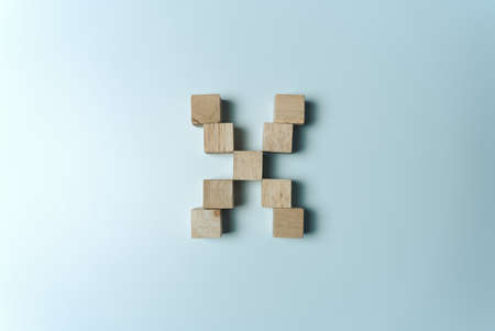 Letter X from wooden dice White Backgroundの写真素材