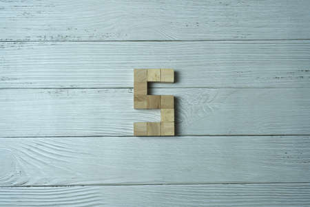 Number 5 from wooden dice on white wooden Backgroundの写真素材