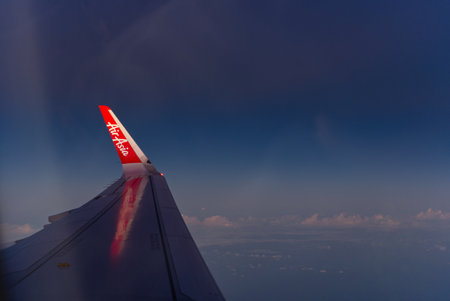 Fukuoka, Japan - December 4, 2022 The early morning sunlight shone on Wing Let from low cost airline Thai AirAsia flight from Bangkok, Thailand to Fukuoka, Japan (Fukuoka airport)のeditorial素材