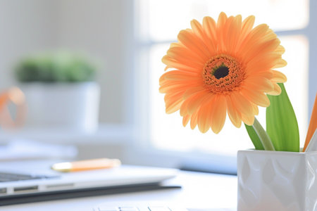 Within the bright confines of an airy office, a close-up shot focuses on the minimalist desk, its surface adorned with a sleek laptop, a tidy organizer containing pens and notebooks, and a single vibrant flower, Generated AIの素材