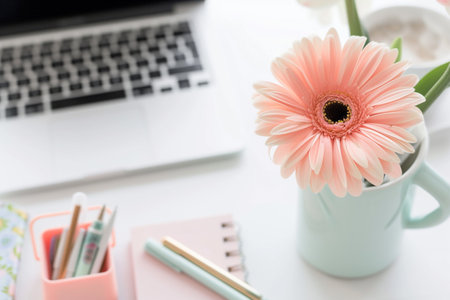 In the close-up view of a minimalist desk within a luminous office space, attention is drawn to the sleek laptop, the minimalist organizer holding pens and notebooks, and a solitary vibrant flower adorning the workspace, Generated AIの素材