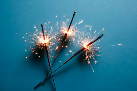 Light Blue Backdrop with One White Sparkler Lit Upの素材