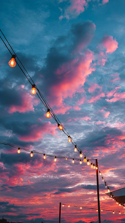 Sunset Sky in Pink and Blue Pastels with Softly Glowing String Lightsの素材