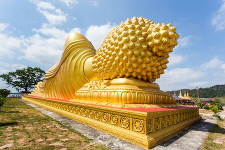Backside of golden buddha statue in temple.の写真素材