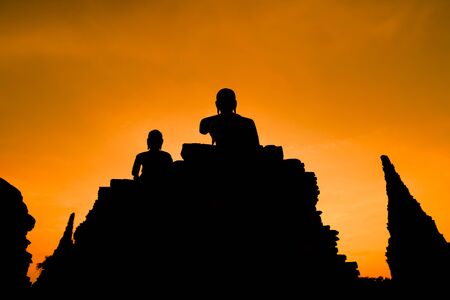 Silhouette big buddha statue in sunset background.の写真素材