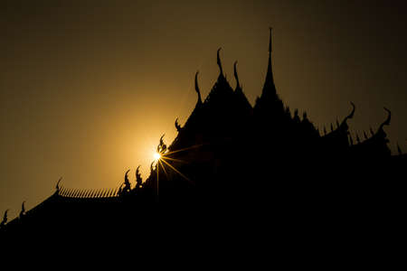 Silhouette of temple historic roof with sunset.の写真素材