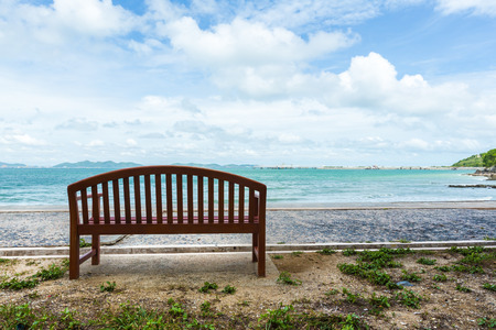 Empty wood chair with a viewpoint looking out to sea.の写真素材