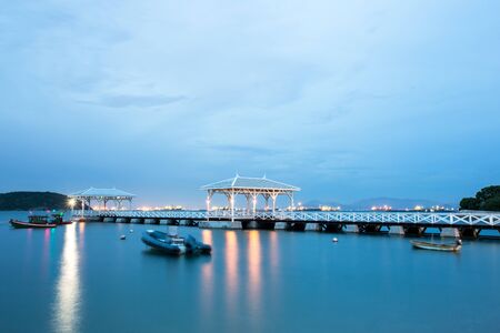 Movement during this long exposure. Twilight sky and bridge column in the sea with Sichang island.の写真素材