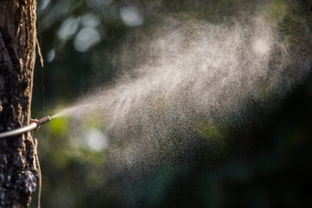 Sprinkling machine water in the garden. Water spray in garden.の写真素材