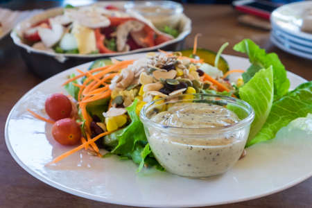 Mix salad chicken with dressing on dish.の写真素材