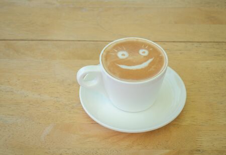 Coffee latte in white glass,wooden backgroundの写真素材