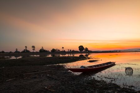 twilight silhouette sunset at tropical sea in Thailand.Fisherman boat.の写真素材